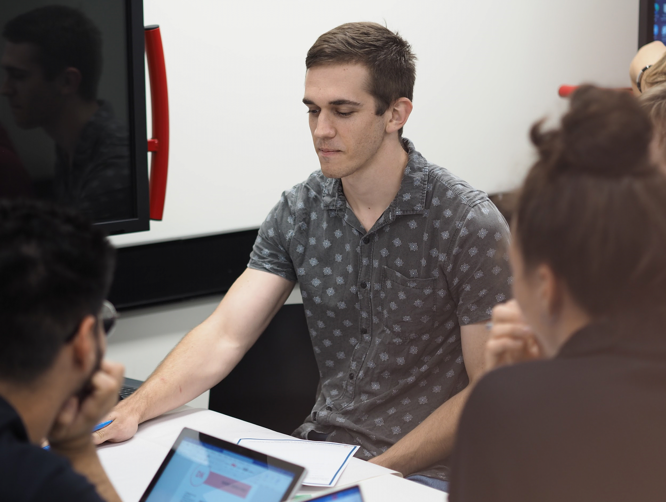 two computers and a laptop on a table
